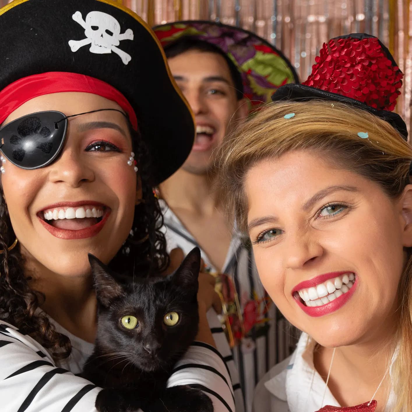 Smiling friends dressed as pirates for a night out