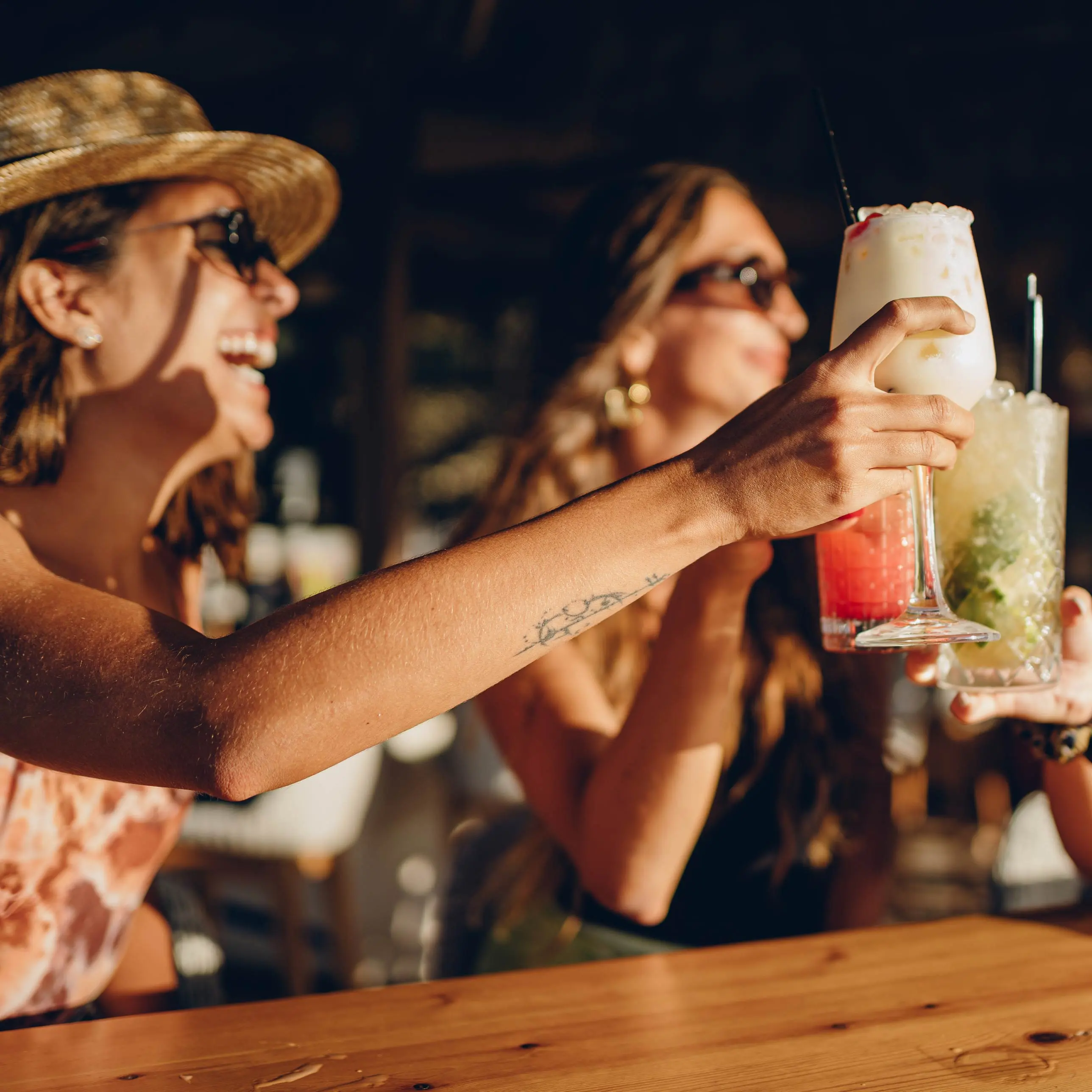 Women toasting cocktails on the Ale and Alibis Pub Crawl