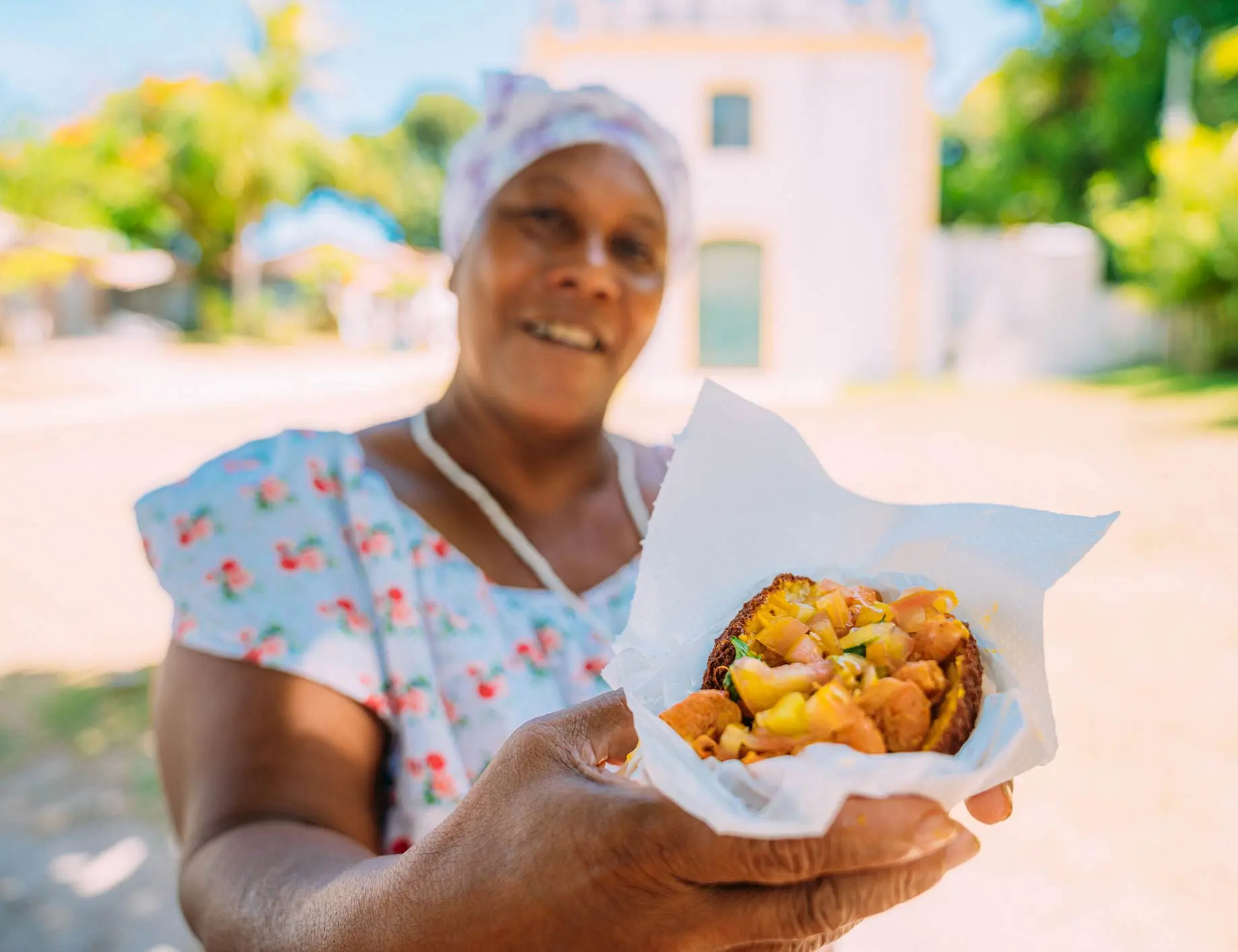 A Revelry Tour Guide showing a Guest some of the food from ouor Charleston Food Tour